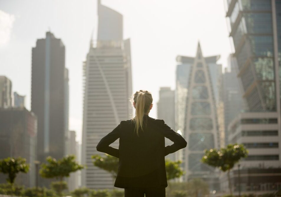 Confident businesswoman standing strong looking at the city high-rises view. Business ambition and aspire.